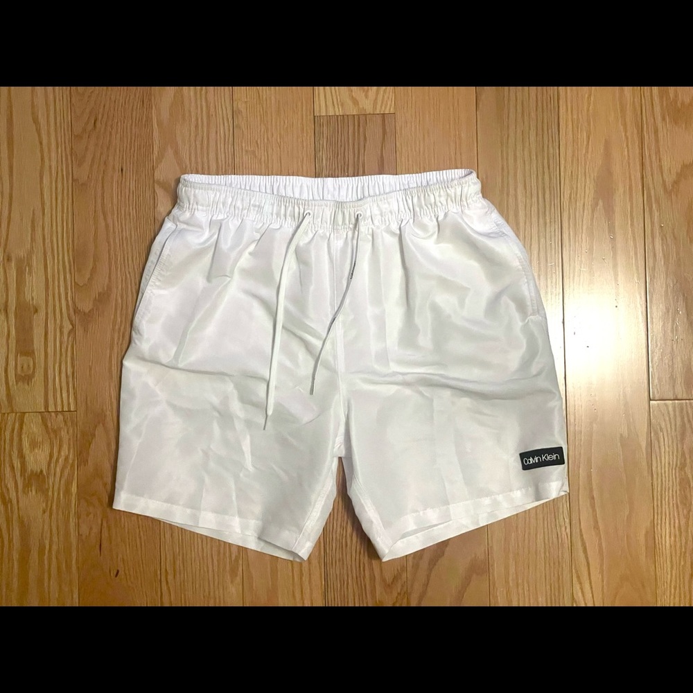White Calvin Klein Swim Trunks, warn and washed, size medium.